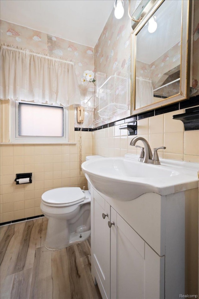 8220 Hartwell St, Detroit, MI 48228 - bathroom with tile walls, wood finished floors, vanity, and backsplash