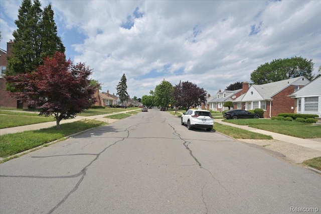 8220 Hartwell St, Detroit, MI 48228 - view of asphalt street featuring sidewalks, a residential view, and curbs