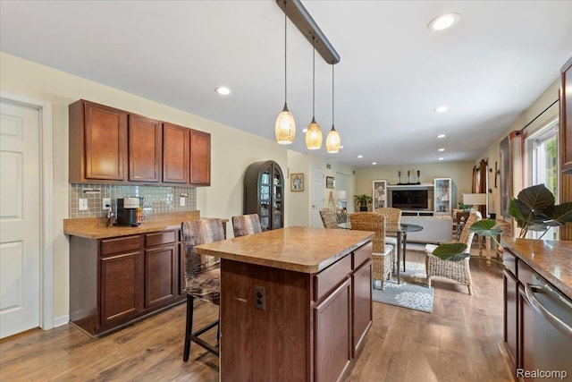 14236 Marshall Dr, Redford, MI 48239 - kitchen featuring stainless steel dishwasher, arched walkways, a breakfast bar, dark wood-type flooring, and recessed lighting
