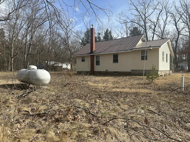 8942 28th Ave, Bitely, MI 49309 - view of side of home with a metal roof and a chimney