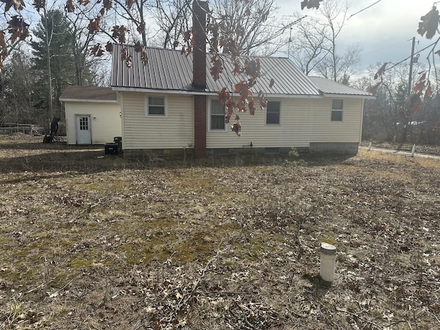 8942 28th Ave, Bitely, MI 49309 - rear view of house with a metal roof, crawl space, and a chimney