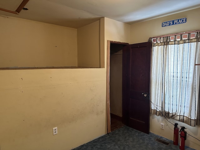 8942 28th Ave, Bitely, MI 49309 - unfurnished bedroom with carpet and multiple windows