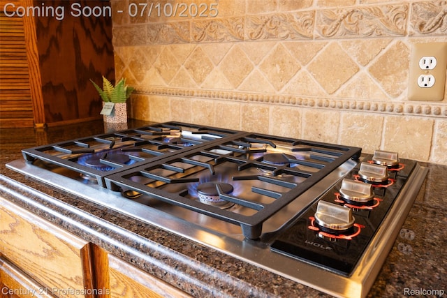 1180 Knob Creek Dr, Rochester, MI 48306 - kitchen view of stainless steel gas cooktop and dark countertops