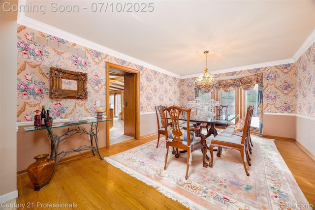 1180 Knob Creek Dr, Rochester, MI 48306 - dining room featuring wallpapered walls, a chandelier, light wood-type flooring, and crown molding