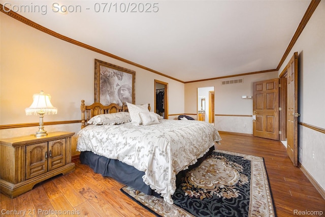 1180 Knob Creek Dr, Rochester, MI 48306 - bedroom featuring wood finished floors, crown molding, a spacious closet, and a wainscoted wall