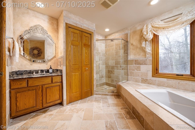 1180 Knob Creek Dr, Rochester, MI 48306 - bathroom with stone tile flooring, a shower stall, a bath, vanity, and recessed lighting