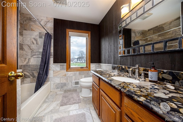 1180 Knob Creek Dr, Rochester, MI 48306 - bathroom featuring tile walls, vanity, and shower / bathtub combination with curtain