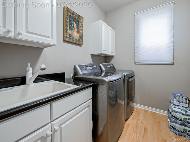 926 Majestic, Rochester Hills, MI 48306 - laundry area with washer and clothes dryer, cabinet space, and light wood-style floors