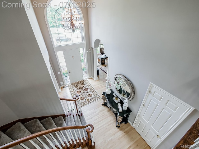 926 Majestic, Rochester Hills, MI 48306 - foyer with arched walkways, a high ceiling, light wood-style flooring, a chandelier, and stairway