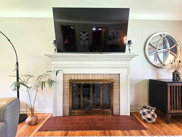 3374 Elmwood St, Clio, MI 48420 - detailed view of wood finished floors and a brick fireplace