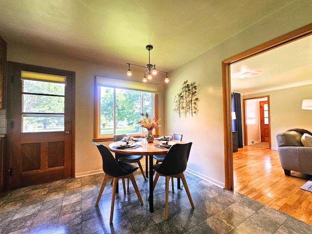 3374 Elmwood St, Clio, MI 48420 - dining space featuring baseboards and dark stone finish floors