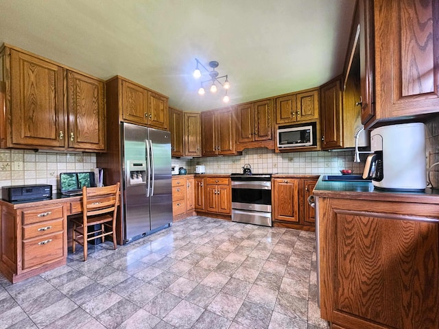 3374 Elmwood St, Clio, MI 48420 - kitchen featuring stainless steel appliances, decorative backsplash, dark countertops, brown cabinetry, and light stone finish flooring