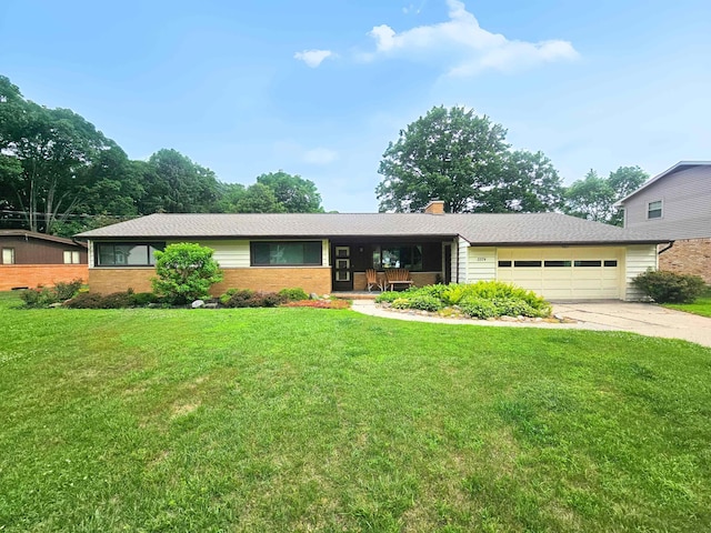 3374 Elmwood St, Clio, MI 48420 - ranch-style home with an attached garage, driveway, a front yard, and brick siding