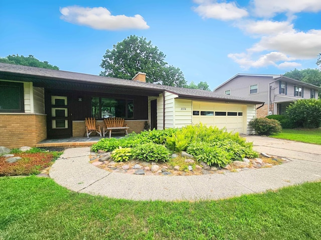 3374 Elmwood St, Clio, MI 48420 - view of front of property featuring a porch, a garage, a chimney, concrete driveway, and brick siding