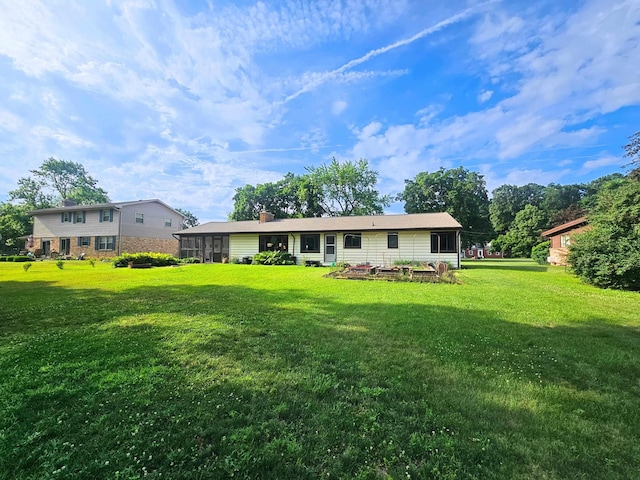 3374 Elmwood St, Clio, MI 48420 - back of property featuring a lawn and a sunroom