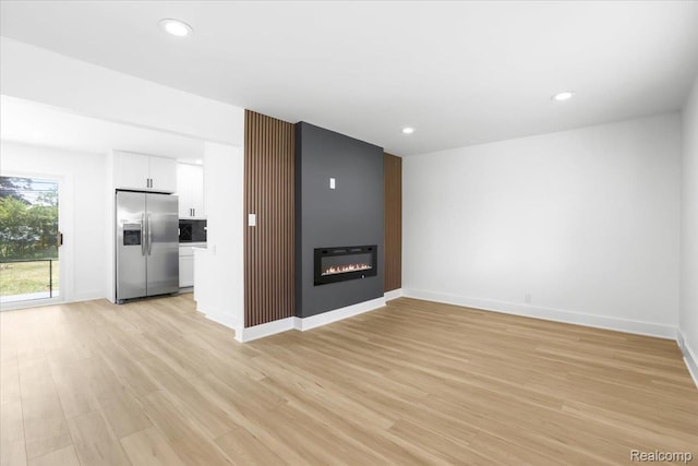 22266 E Schafer St, Clinton Township, MI 48035 - unfurnished living room with light wood finished floors, a fireplace, and recessed lighting