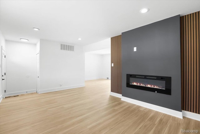 22266 E Schafer St, Clinton Township, MI 48035 - unfurnished living room featuring light wood finished floors, recessed lighting, and a glass covered fireplace