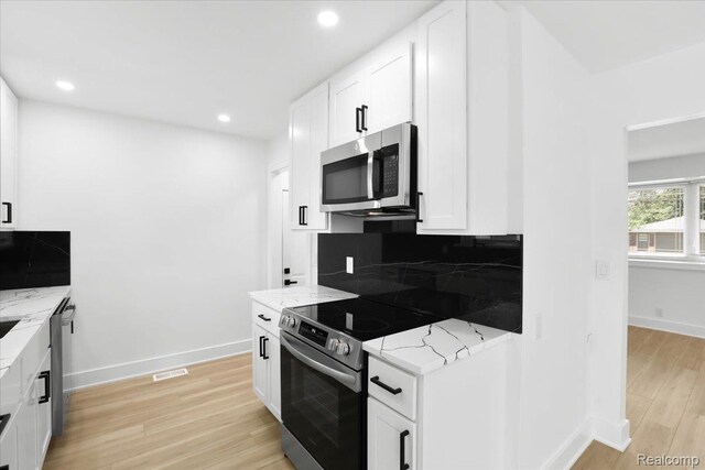 22266 E Schafer St, Clinton Township, MI 48035 - kitchen featuring stainless steel appliances, light stone counters, light wood finished floors, white cabinets, and recessed lighting