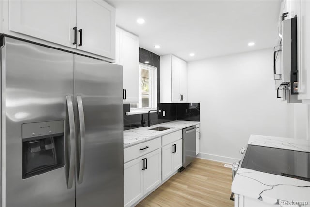 22266 E Schafer St, Clinton Township, MI 48035 - kitchen featuring appliances with stainless steel finishes, white cabinets, light stone countertops, light wood-type flooring, and recessed lighting