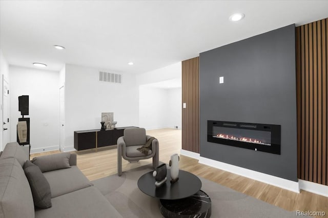 22266 E Schafer St, Clinton Township, MI 48035 - living room with wood finished floors, a glass covered fireplace, and recessed lighting