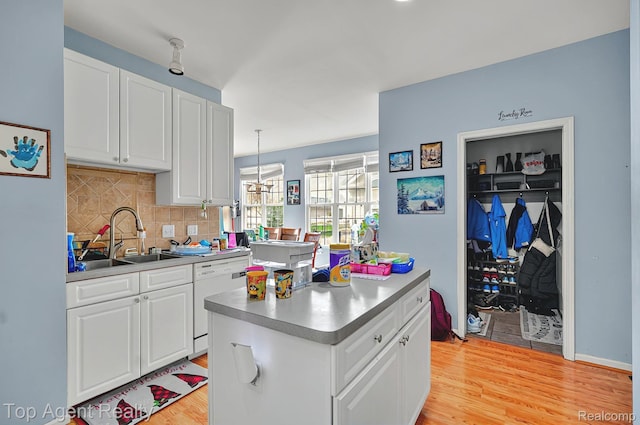 34658 Pine Vly, Richmond, MI 48062 - kitchen featuring white dishwasher, light wood-style floors, decorative backsplash, and white cabinets