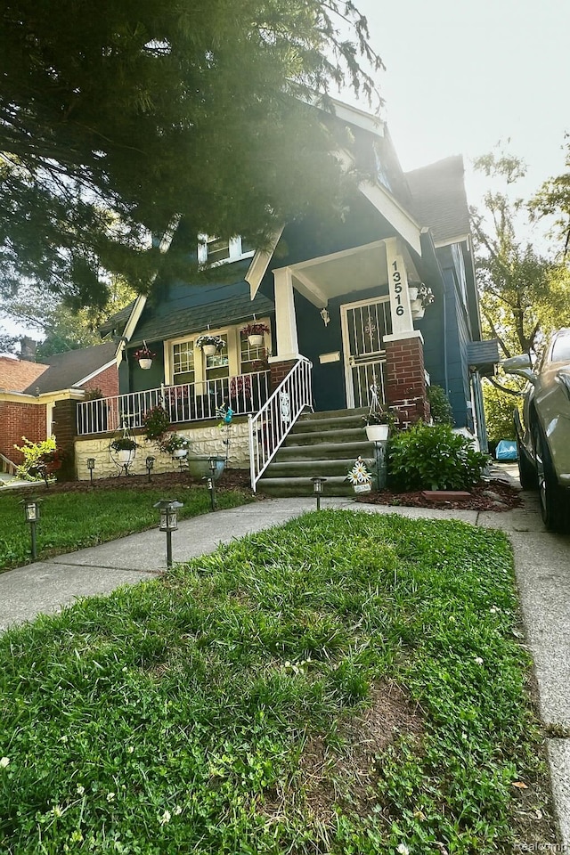 13516 Mansfield St, Detroit, MI 48227 - view of front of house featuring covered porch and brick siding