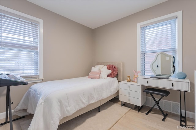 2544 S Beatrice St, Detroit, MI 48217 - bedroom featuring multiple windows, light wood finished floors, and an office area