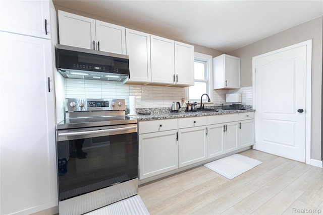 2544 S Beatrice St, Detroit, MI 48217 - kitchen featuring stainless steel appliances, backsplash, white cabinets, light wood-type flooring, and light stone countertops