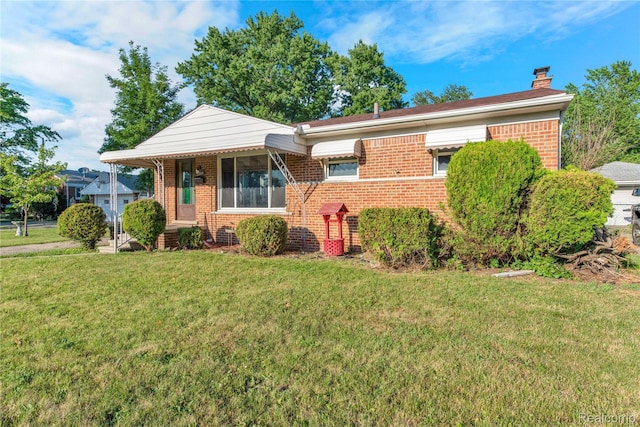 22610 Karam Ct, Macomb, MI 48091 - view of front of house featuring brick siding, a front yard, and a chimney