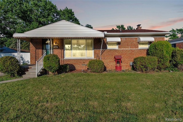 22610 Karam Ct, Macomb, MI 48091 - bungalow with brick siding, a yard, and a chimney