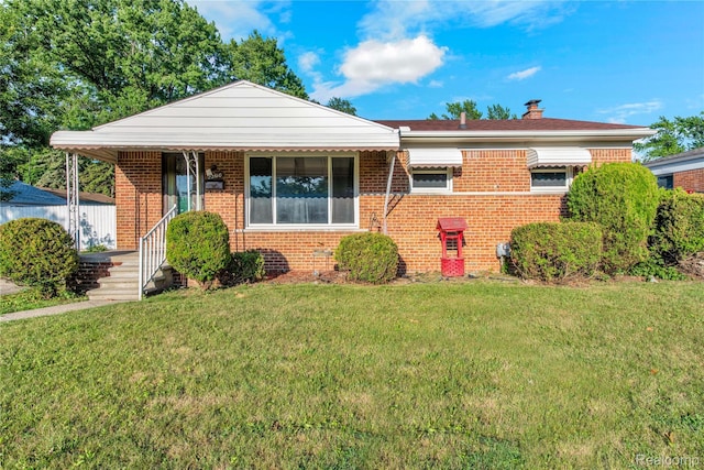 22610 Karam Ct, Macomb, MI 48091 - view of front of property featuring a front yard, brick siding, a chimney, and covered porch