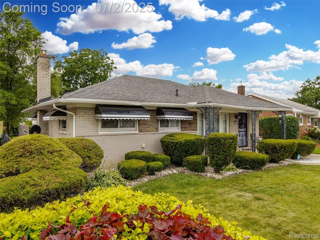 4910 Julius Blvd, Westland, MI 48186 - back of house featuring a chimney, a lawn, brick siding, and roof with shingles