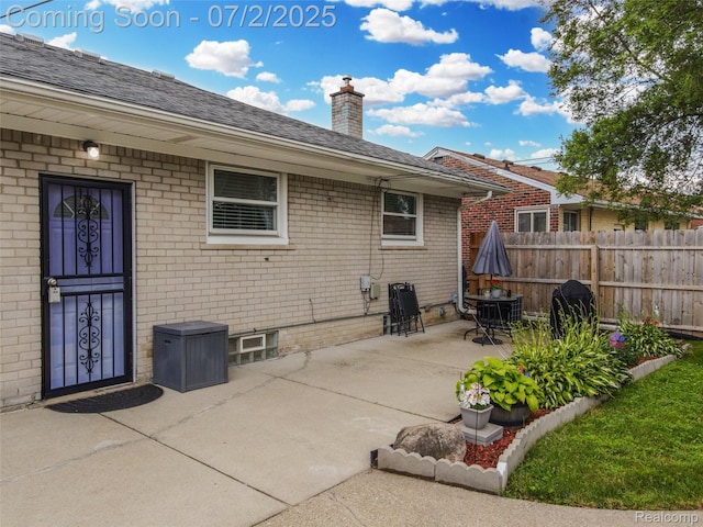 4910 Julius Blvd, Westland, MI 48186 - back of property with a chimney, brick siding, a patio, and roof with shingles