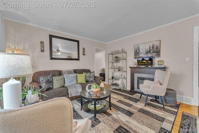4910 Julius Blvd, Westland, MI 48186 - living room with ornamental molding, wood finished floors, and a glass covered fireplace