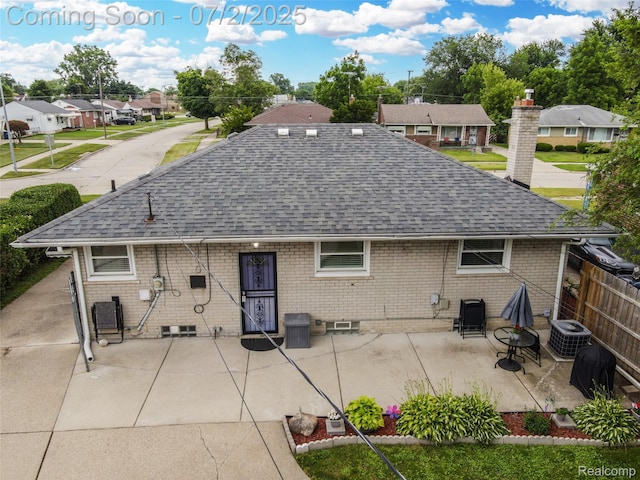 4910 Julius Blvd, Westland, MI 48186 - back of house with a shingled roof, a patio area, a residential view, and brick siding