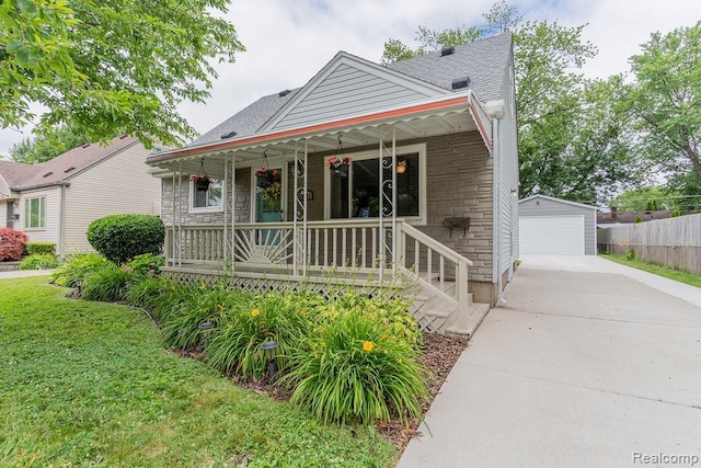 23631 Beverly St, Saint Clair Shores, MI 48082 - view of front of property with stone siding, a porch, an outbuilding, a detached garage, and a shingled roof