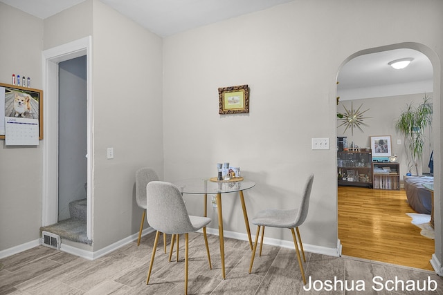 908 Chatham St NW, Grand Rapids, MI 49504 - dining room with arched walkways, wood finished floors, and stairs