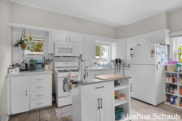 908 Chatham St NW, Grand Rapids, MI 49504 - kitchen featuring white appliances, open shelves, white cabinetry, and light countertops