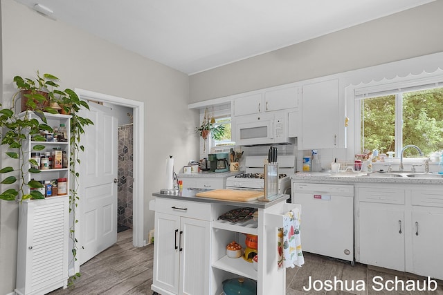 908 Chatham St NW, Grand Rapids, MI 49504 - kitchen featuring white appliances, open shelves, white cabinetry, and healthy amount of natural light