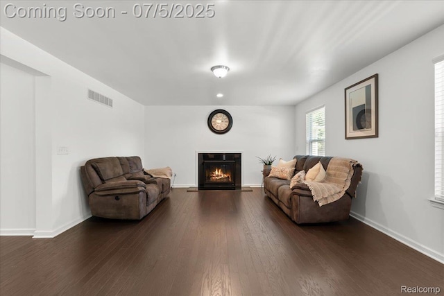 21422 Navarra Dr, South Lyon, MI 48178 - living room with dark wood finished floors and a lit fireplace