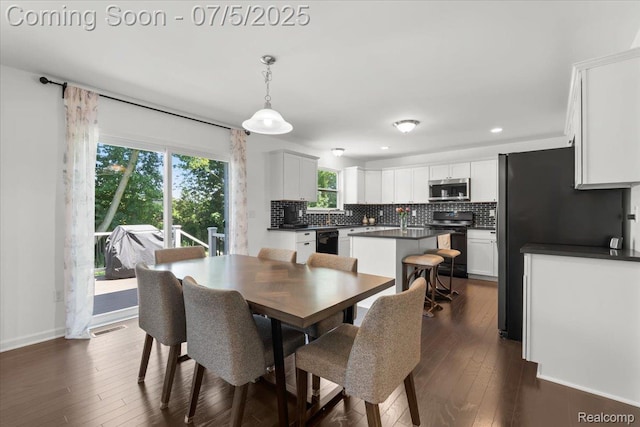 21422 Navarra Dr, South Lyon, MI 48178 - dining room featuring dark wood-type flooring and recessed lighting