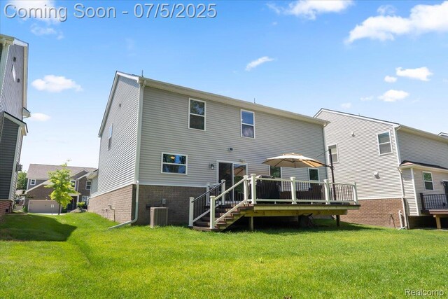 21422 Navarra Dr, South Lyon, MI 48178 - back of house featuring a wooden deck, a yard, and brick siding