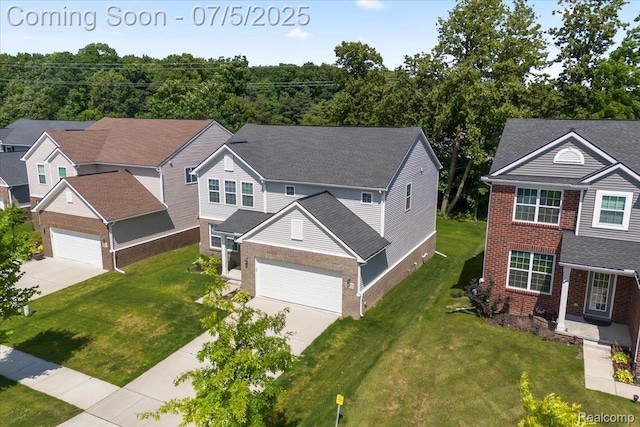 21422 Navarra Dr, South Lyon, MI 48178 - view of front of home featuring brick siding, concrete driveway, and a front yard