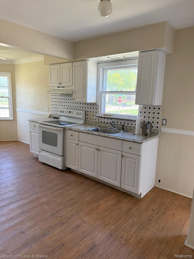 10056 Garfield, Redford, MI 48239 - kitchen featuring white range with electric cooktop, under cabinet range hood, a wainscoted wall, light wood-style floors, and white cabinets
