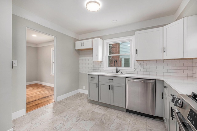 1816 Jennette Ave NW, Grand Rapids, MI 49504 - kitchen featuring dishwasher, range, light countertops, and gray cabinetry