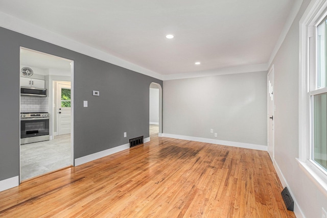 1816 Jennette Ave NW, Grand Rapids, MI 49504 - spare room featuring arched walkways, light wood-type flooring, and recessed lighting