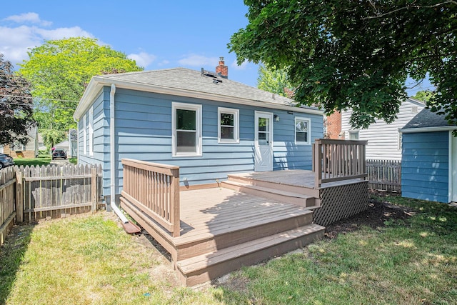 1816 Jennette Ave NW, Grand Rapids, MI 49504 - rear view of property featuring a wooden deck, a chimney, and a shingled roof