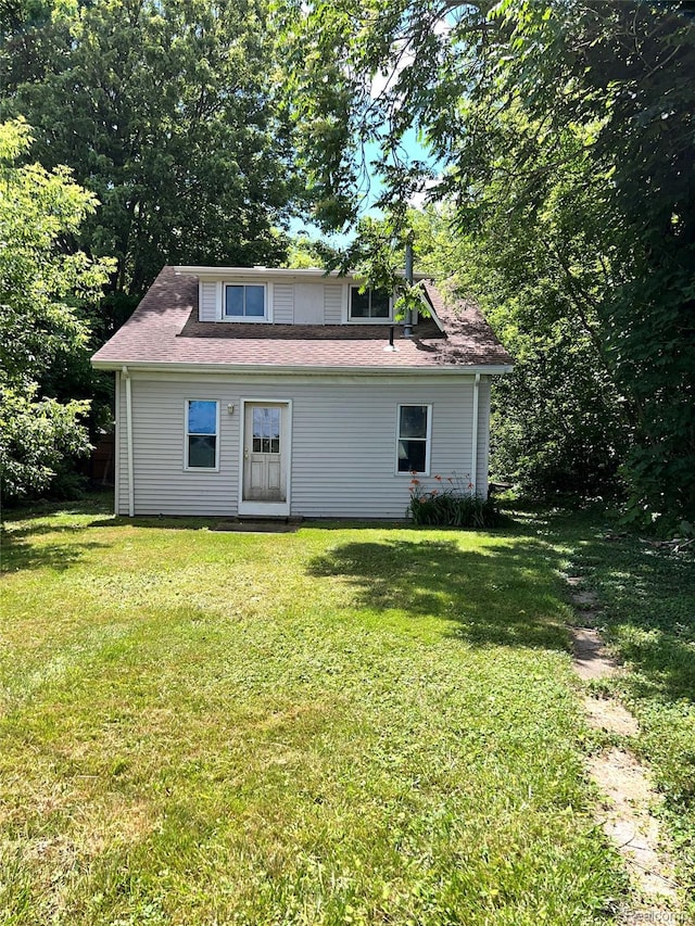 8956 Dixie Hwy, Ira, MI 48023 - rear view of house featuring a lawn