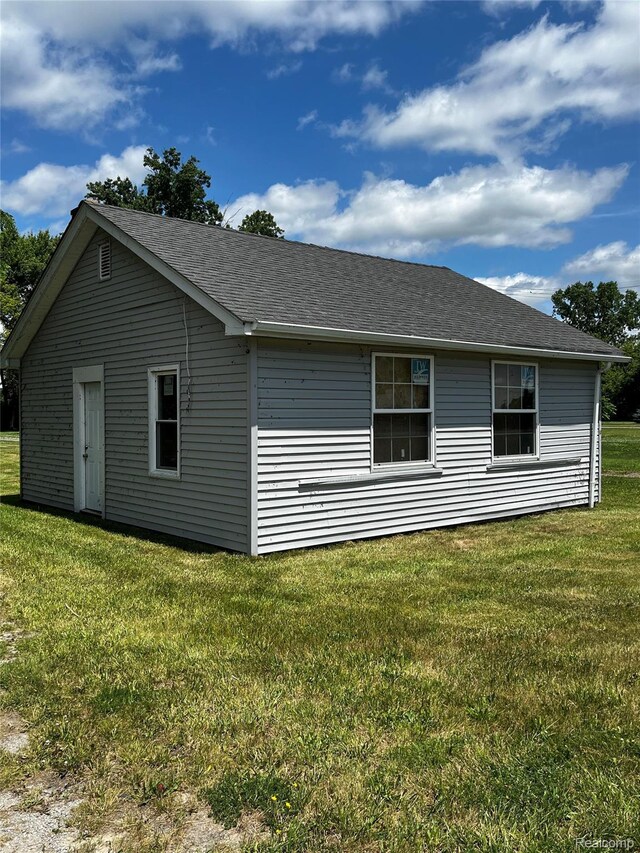 8956 Dixie Hwy, Ira, MI 48023 - view of home's exterior featuring a yard and roof with shingles