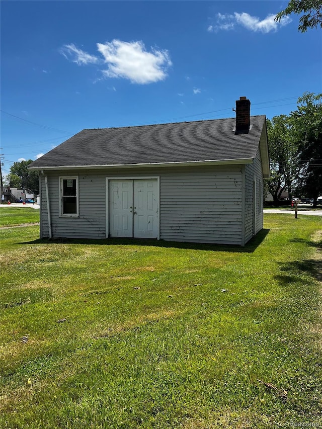 8956 Dixie Hwy, Ira, MI 48023 - back of house with a chimney, a yard, and an outbuilding